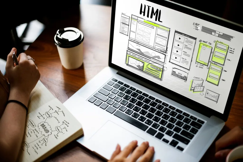 Web designer sketching a website layout while researching which CMS to use