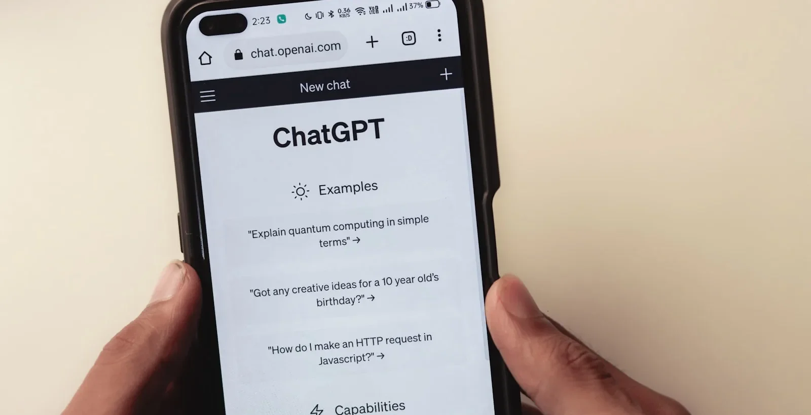A person using ChatGPT on a smartphone, illustrating that ads reach only Free and Go users