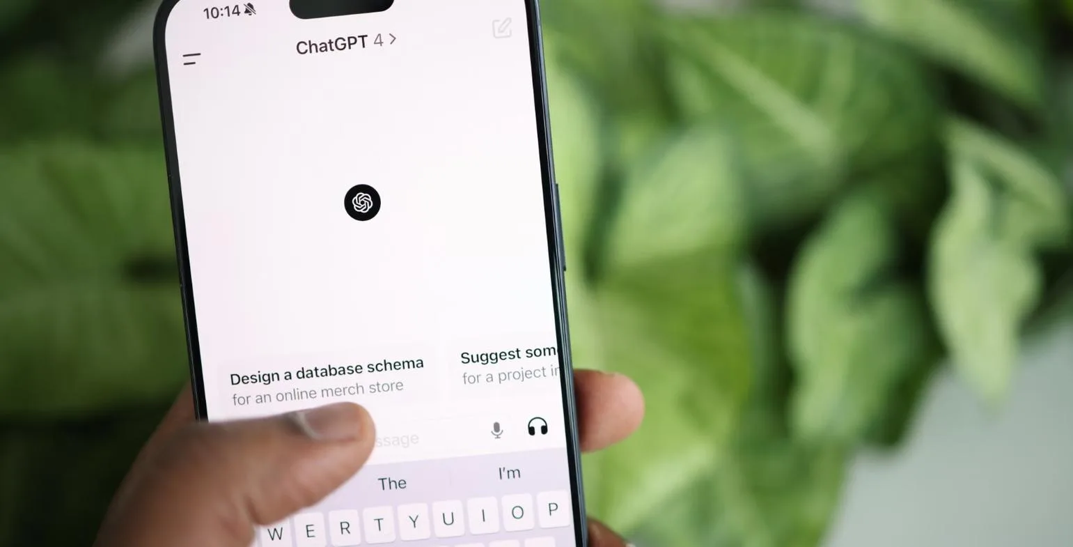 Hand holding a smartphone showing the ChatGPT app answering a question