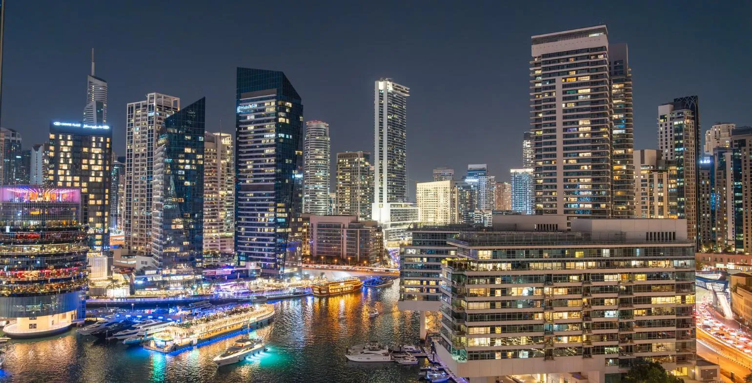 Dubai Marina skyline lit up at night, representing MENA and global brands