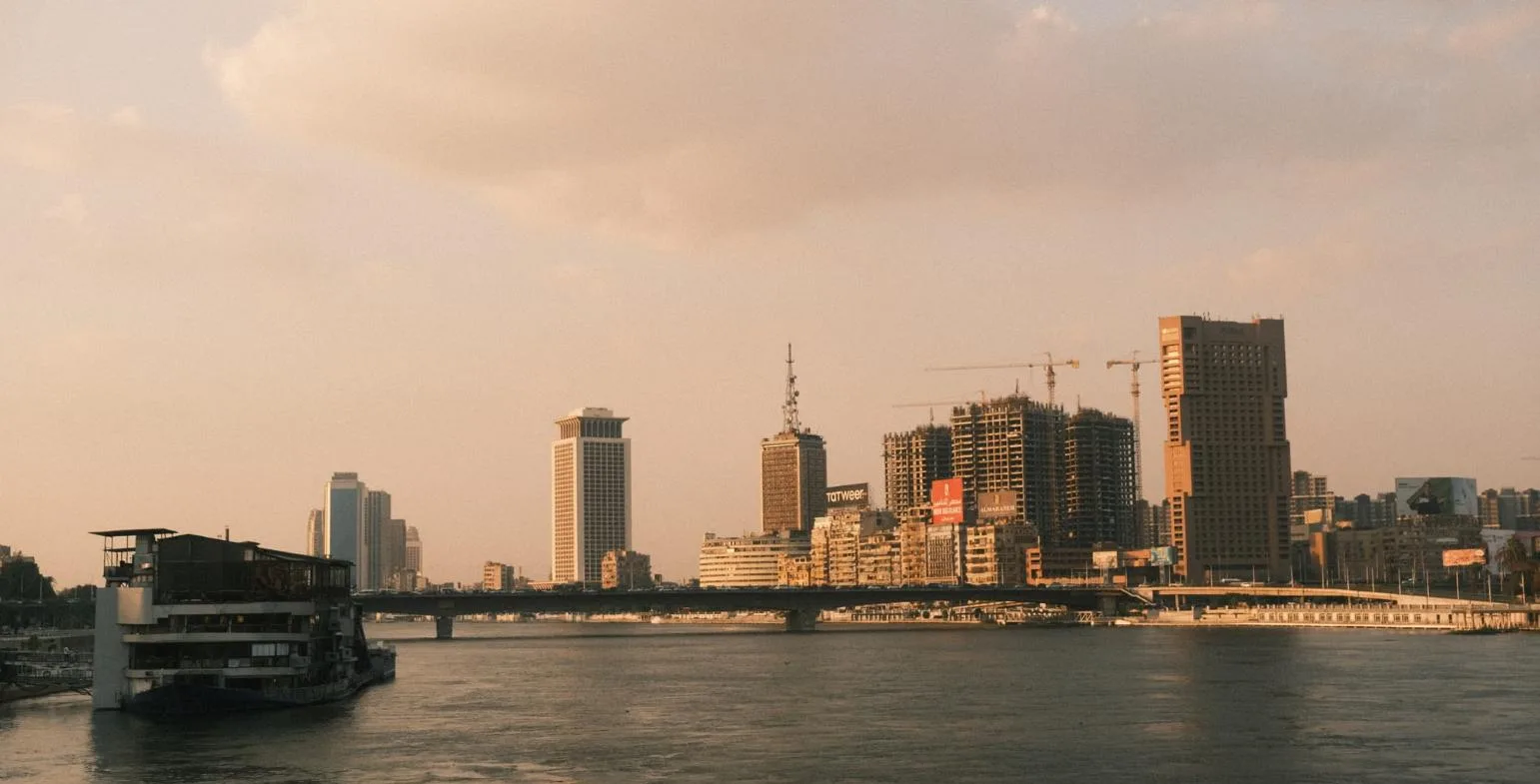 Cairo skyline and the Nile river at golden hour with modern towers