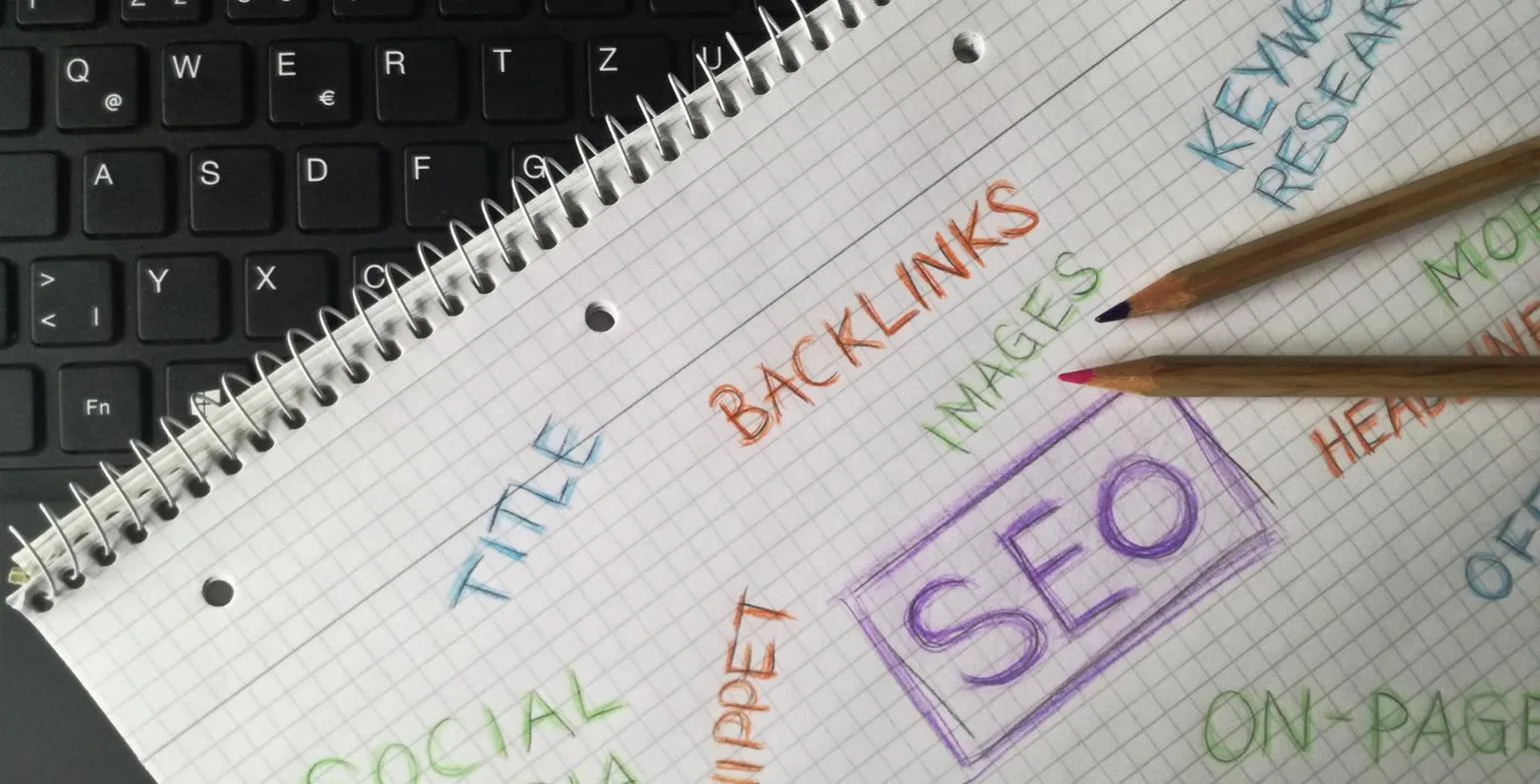 Notebook mind map with handwritten SEO terms including keyword research, title and backlinks