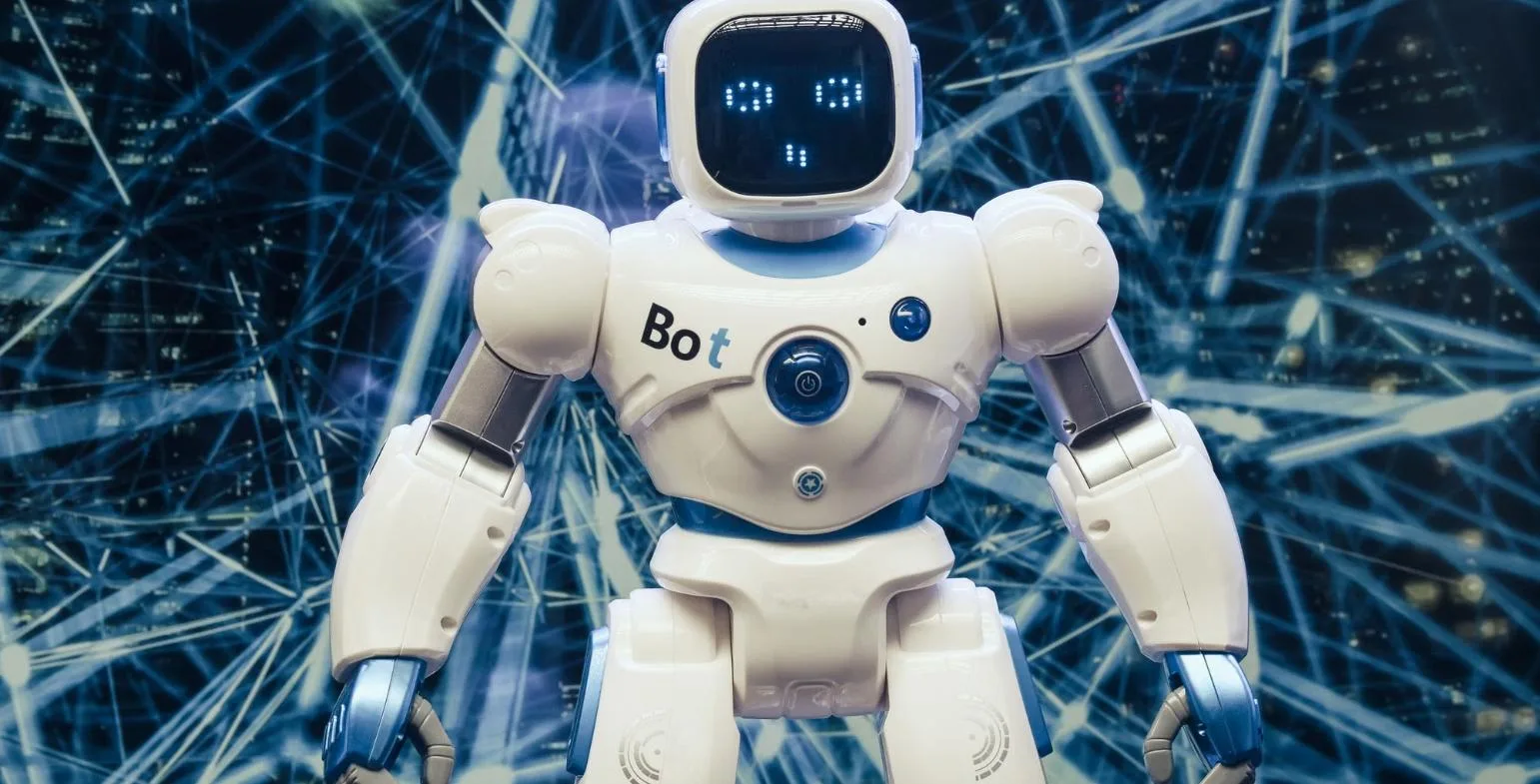 White robot standing in front of a blue network of connected data lines