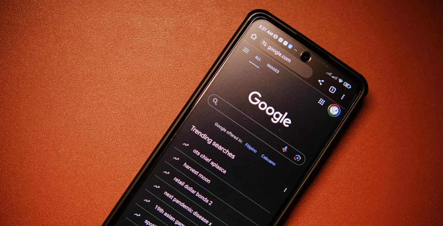 Smartphone showing the Google homepage with a list of trending searches