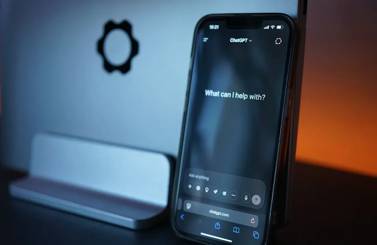 Smartphone showing the ChatGPT app interface asking "What can I help with?"